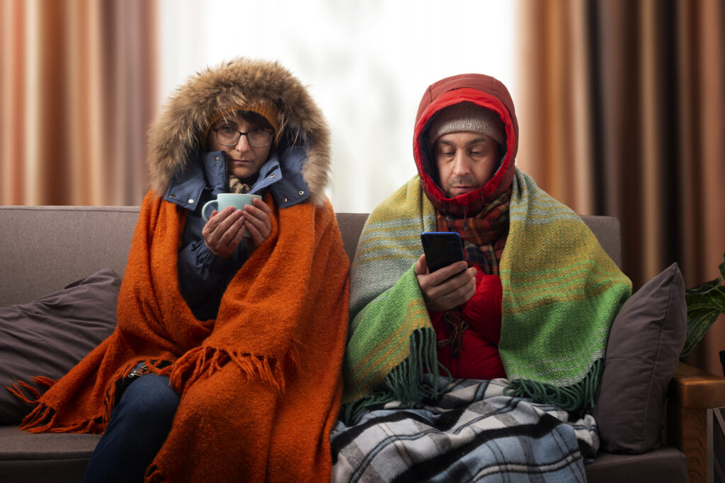 Homeowners in coats in blankets furnace not working